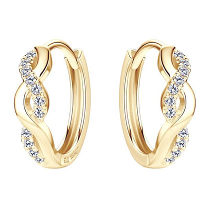 Light reflection on spiral huggie earrings showing moissanite fire and sterling silver polish quality
