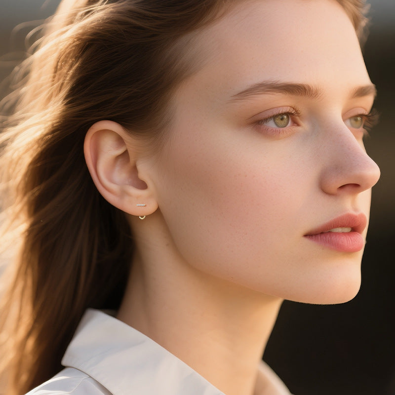 Woman wearing hypoallergenic gold stud earrings lifestyle shot