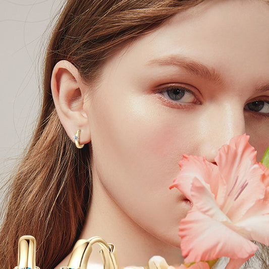 Side profile of minimalist huggie hoops showing clasp