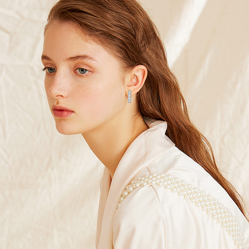 Luckinging Huggie Earrings in elegant display setting