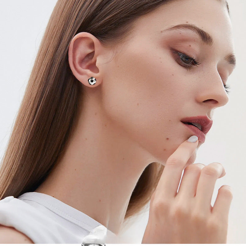 Close-up of black moissanite in sterling silver football stud earring