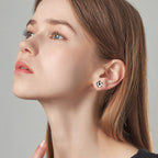 Pair of Luckinging football moissanite stud earrings on model ear