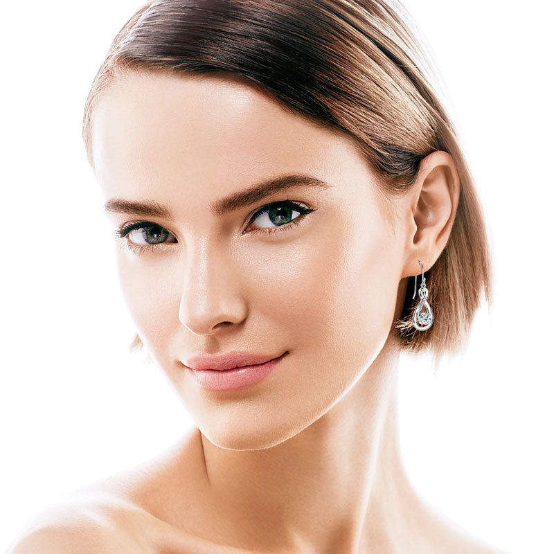 Side view of silver moissanite drop earring showing design detail
