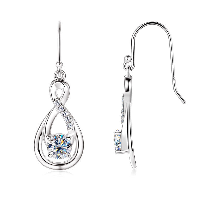 Profile view of dangling silver moissanite earring on model ear