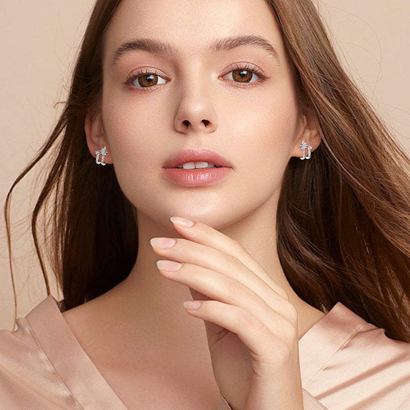 Close detail of silver star earrings with small moissanite stones