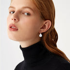Side angle shot showcasing the curve and drop length of the teardrop earrings