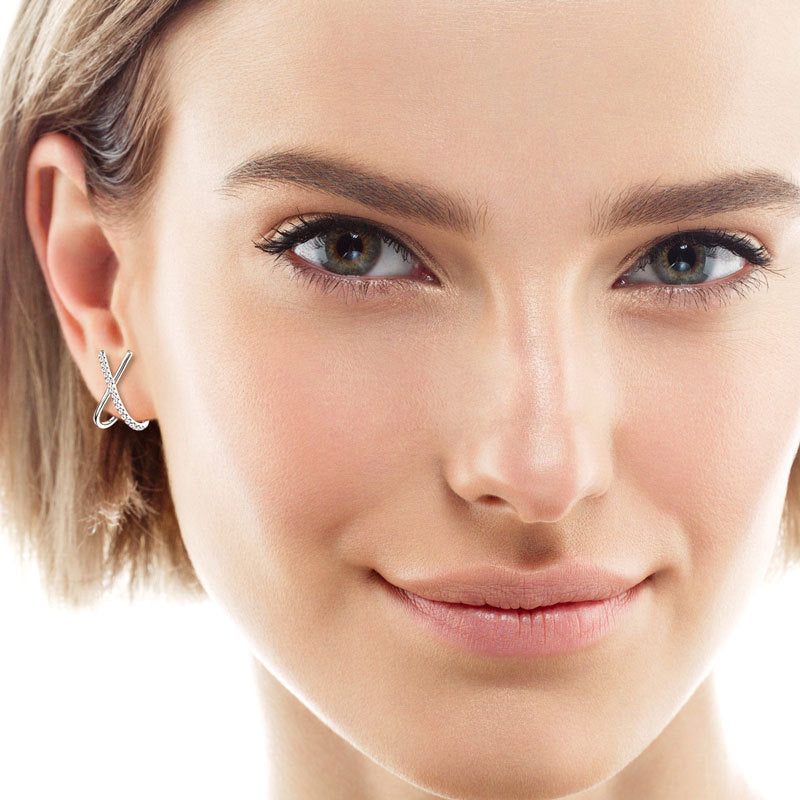 Detail shot of moissanite stones in Luckinging x-shaped stud earrings