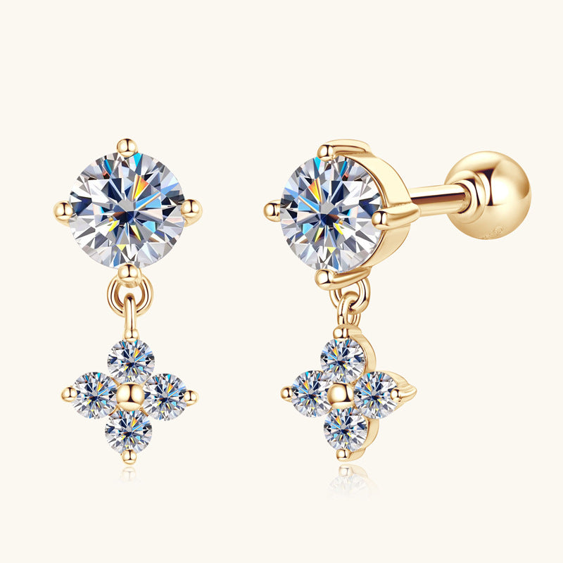 Front view of golden floral dangle earring with moissanite center stone