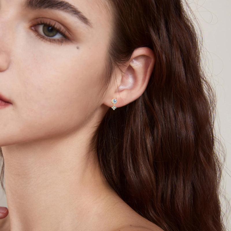 Image of gold dangle earring with moissanite dropped gracefully