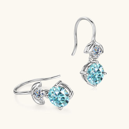 Close-up detail of the 6.5mm Mermaid Blue Moissanite stone in the earring