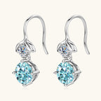 Side angle shot of the teardrop Moissanite earrings highlighting their dangle form