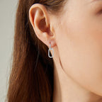Woman wearing minimalist gold stud earrings lifestyle photo