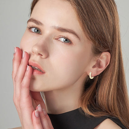Side profile view of moissanite huggie earrings in sterling silver
