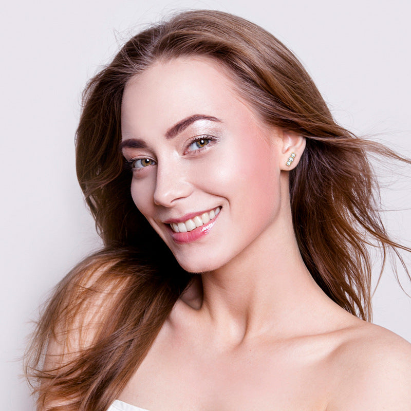 Professional styling shot of moissanite sterling silver studs worn with minimalist jewelry