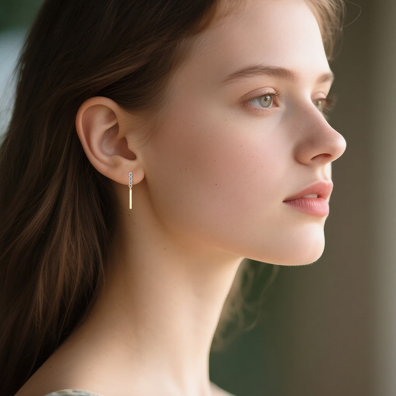Brilliant moissanite stones reflecting light in sterling silver huggie hoop earring setting
