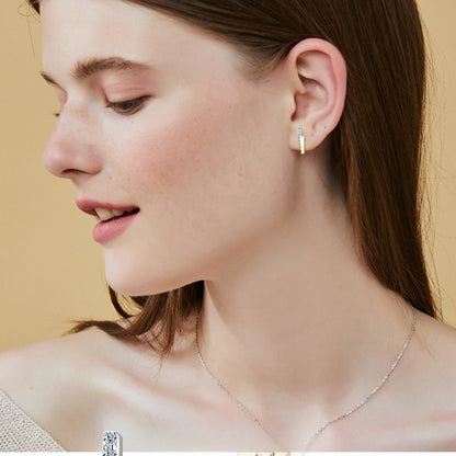 Close-up detail of genuine moissanite stones in sterling silver hoop earring settings