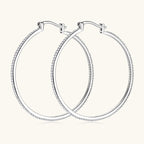 Side angle view of the silver moissanite stud earrings