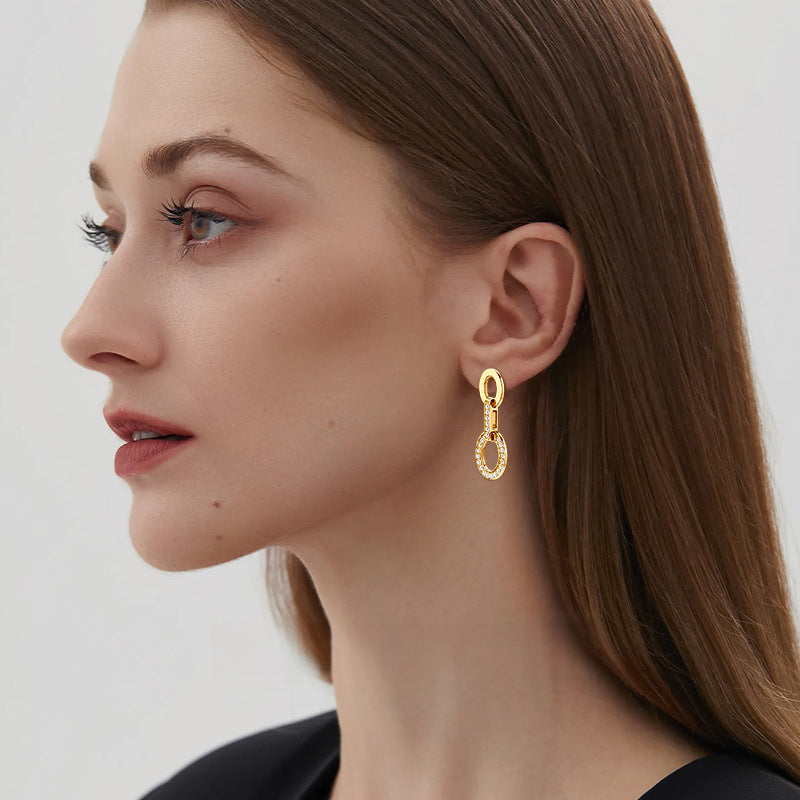 Close-up of the adjustable stackable ring on silver hoop earrings