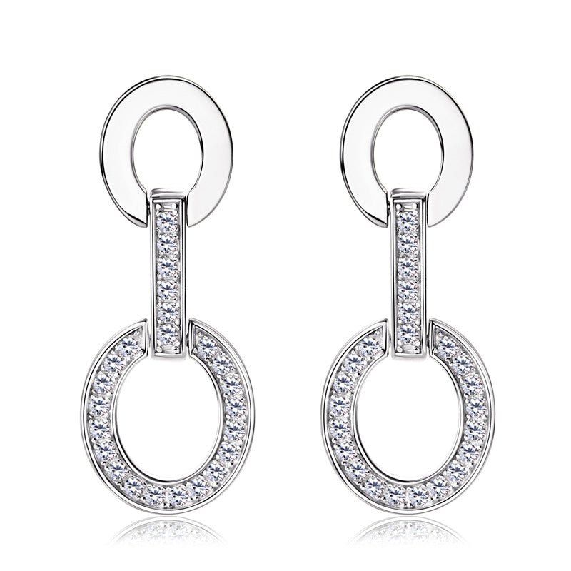 Minimalist silver hoop earrings in natural light