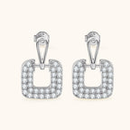 Profile view of silver square dangling earring