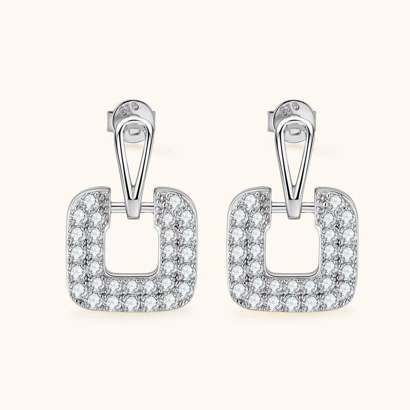 Profile view of silver square dangling earring