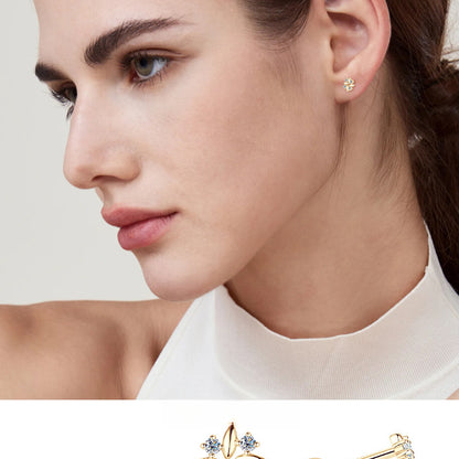 Closeup detail of small gold huggie earrings highlighting flat back design features