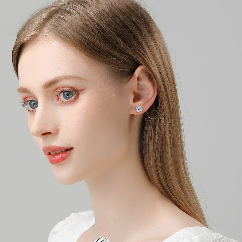 Close up detail of hinged closure mechanism on small gold hoop earrings