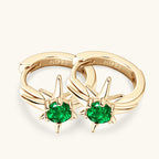 Lifestyle image of the star emerald huggie earrings being worn