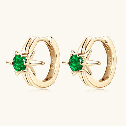 Pair of star emerald huggie earrings displayed together showing matching gemstones