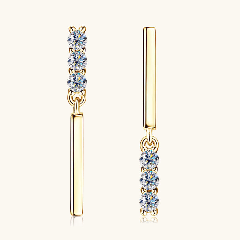 Woman wearing sterling silver flat back moissanite huggie earrings showing comfortable fit and sparkle