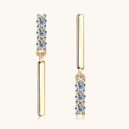 Woman wearing sterling silver flat back moissanite huggie earrings showing comfortable fit and sparkle