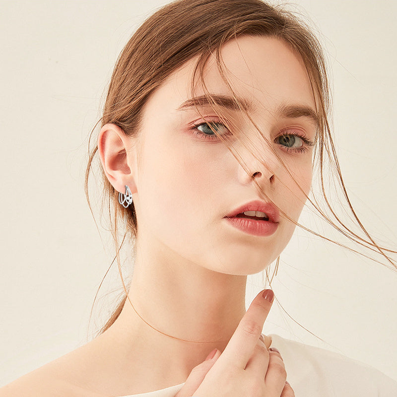 Professional woman wearing minimalist moissanite studs business meeting confident sophisticated look