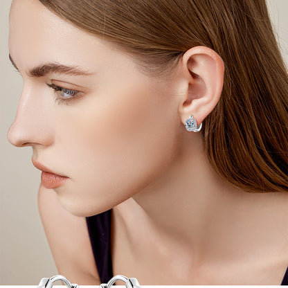 Woman wearing elegant moissanite hoop earrings in professional setting